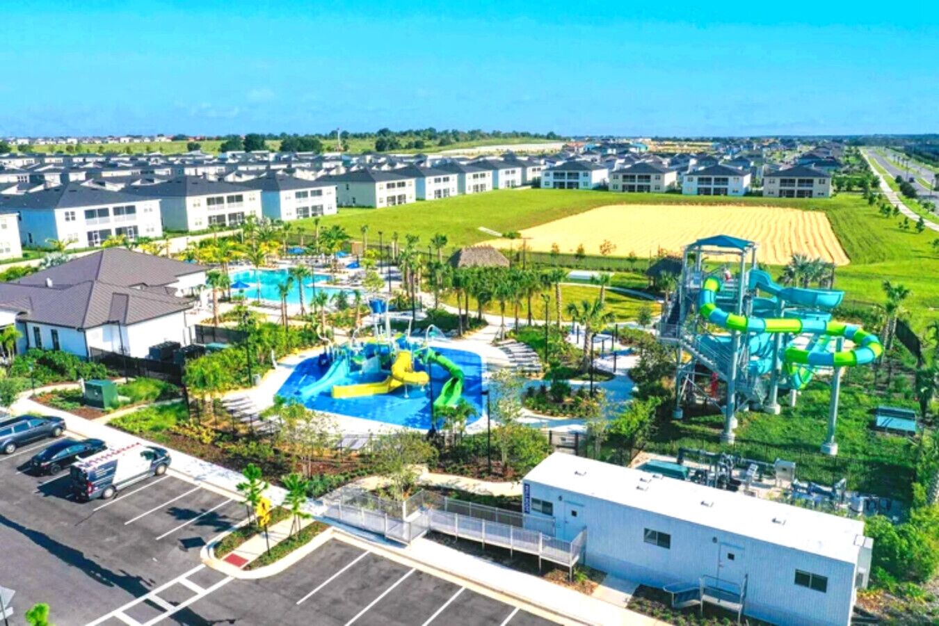 A resort with multiple swimming pools, water slides, and a parking area.