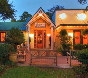 A restaurant with a signboard, a bench, and a pathway leading to the entrance. - The Cleverdon Cottage- Historic Magnolia Springs Retreat- 4 bedroom, 2.5 bath (Magnolia Springs)