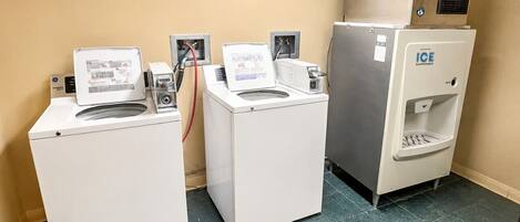 A laundry facility with three washing machines and an ice dispenser.