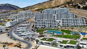 A modern hotel complex with multiple buildings, a swimming pool, and a hilly backdrop. - Exclusive Apartment. Relax, Luxury and Sea Views (Finestrat)