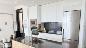 A modern kitchen with a stainless steel refrigerator, a built-in microwave, and a coffee machine. - Beautiful villa with private pool and sea views (Polop)