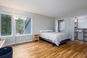 A bedroom with a bed, a bedside table, a lamp, a window, and built-in shelving. - 3-bed/2-bath Townhouse, Near Hospital & Parks (Troy)
