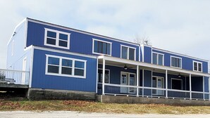 A two-story building with a balcony and a covered porch. - 6 Bedroom - 5.5 Bath - Second Tier (Climax Springs)