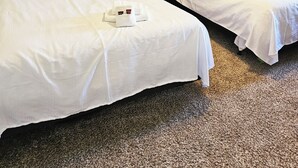 A hotel room with two beds, a ceiling fan, and two paintings on the walls. - 6 Bedroom - 5.5 Bath - Second Tier (Climax Springs)