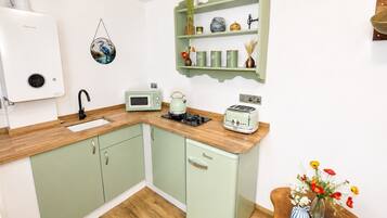 Fridge, microwave, coffee/tea maker, cookware/dishes/utensils
