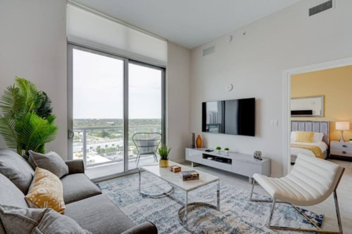 A modern living room with a sofa, coffee table, and TV.