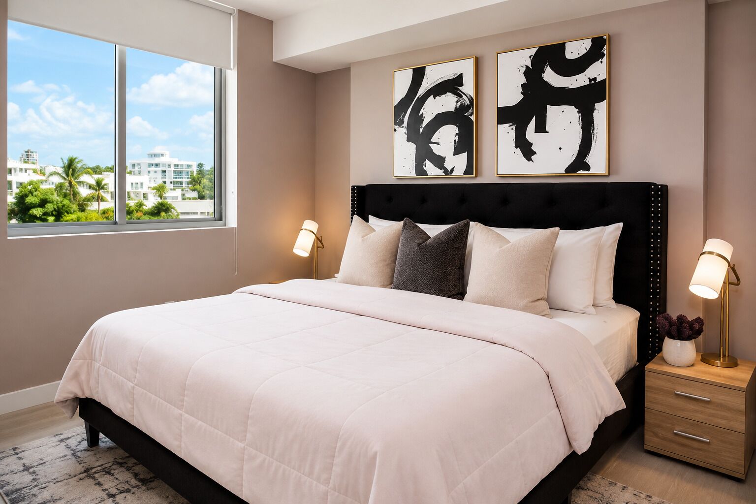 A bedroom with a bed, bedside tables, and artwork on the wall.