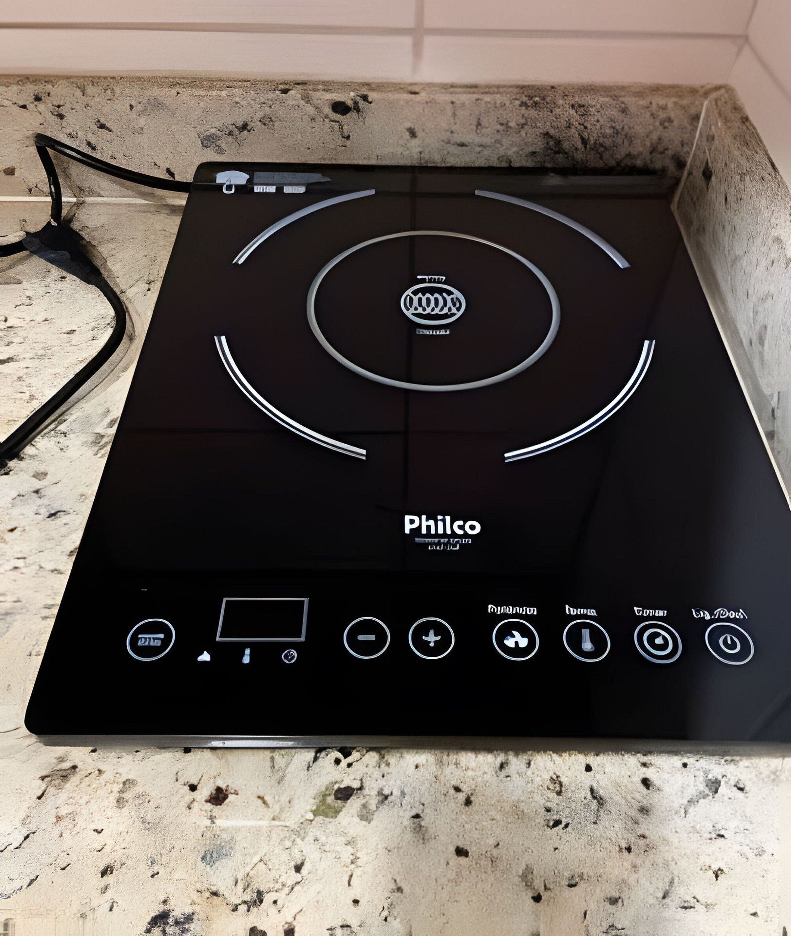 A black Philco induction cooktop with a control panel featuring various buttons and a display screen.