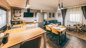 A modern kitchen with a dining area, wooden countertops, and a built-in oven.