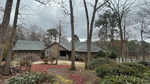 A house with a stone facade, a front porch, and a garage.