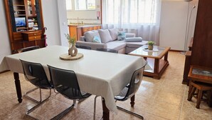 A dining area with a table, chairs, and a television in the background. - Portas de Melgaço Apartment | Minho | The northernmost town in Portugal (Melgaço)