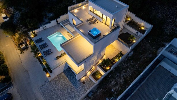 A modern two-story house with a swimming pool, hot tub, and outdoor seating area. - Luxury Villa Oasis with pool and jacuzzi near beach (Trogir)