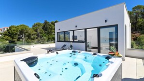 A modern rooftop with a hot tub, glass doors, and a view of the surrounding landscape. - Luxury Villa Oasis with pool and jacuzzi near beach (Trogir)