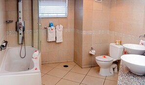 A bathroom with a bathtub, toilet, and sink, all in white.