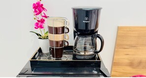 A coffee maker and a glass mug on a tray. - Suite 08 • 2 Bedrooms • Boutique Mansion (Guayaquil)