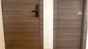 A wooden door with a black handle and a keyhole. - Suite 09 • Private Suite • Boutique Mansion (Guayaquil)