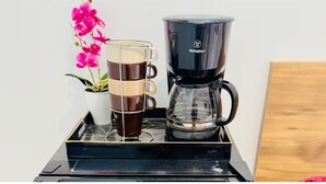 A coffee maker and a glass mug on a tray. - Suite 09 • Private Suite • Boutique Mansion (Guayaquil)