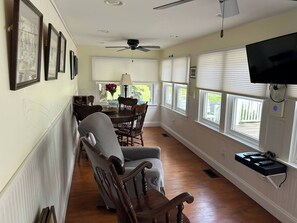 A dining area with a table, chairs, and a ceiling fan. - Completely revamped Eastern Shore home (Onley)