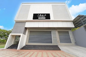 A modern building with a sign reading 'Collection' and 'OYO-Serviced'.
