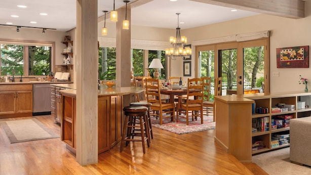 A spacious kitchen with wooden cabinets, a central island, and pendant lighting. - Abode at Guyer Hot Springs, walk to lift, hot tub (Ketchum)