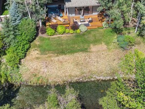 A residential property with a hot tub, outdoor seating area, and a view of a river. - Abode at Guyer Hot Springs, walk to lift, hot tub (Ketchum)