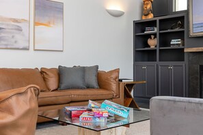 Una televisión, una chimenea, videojuegos, una mesa de tenis de mesa