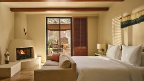 A bedroom with a fireplace, a bed, a sofa, and a view of the outdoors. - 2-bedroom Resort in soothing Scottsdale with AC and fitness room (Scottsdale)