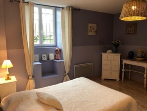 A bedroom with a bed, a dresser, a desk, a window with curtains, and a hanging lamp. - La Glycine 5/6 persons (LA CANOURGUE)