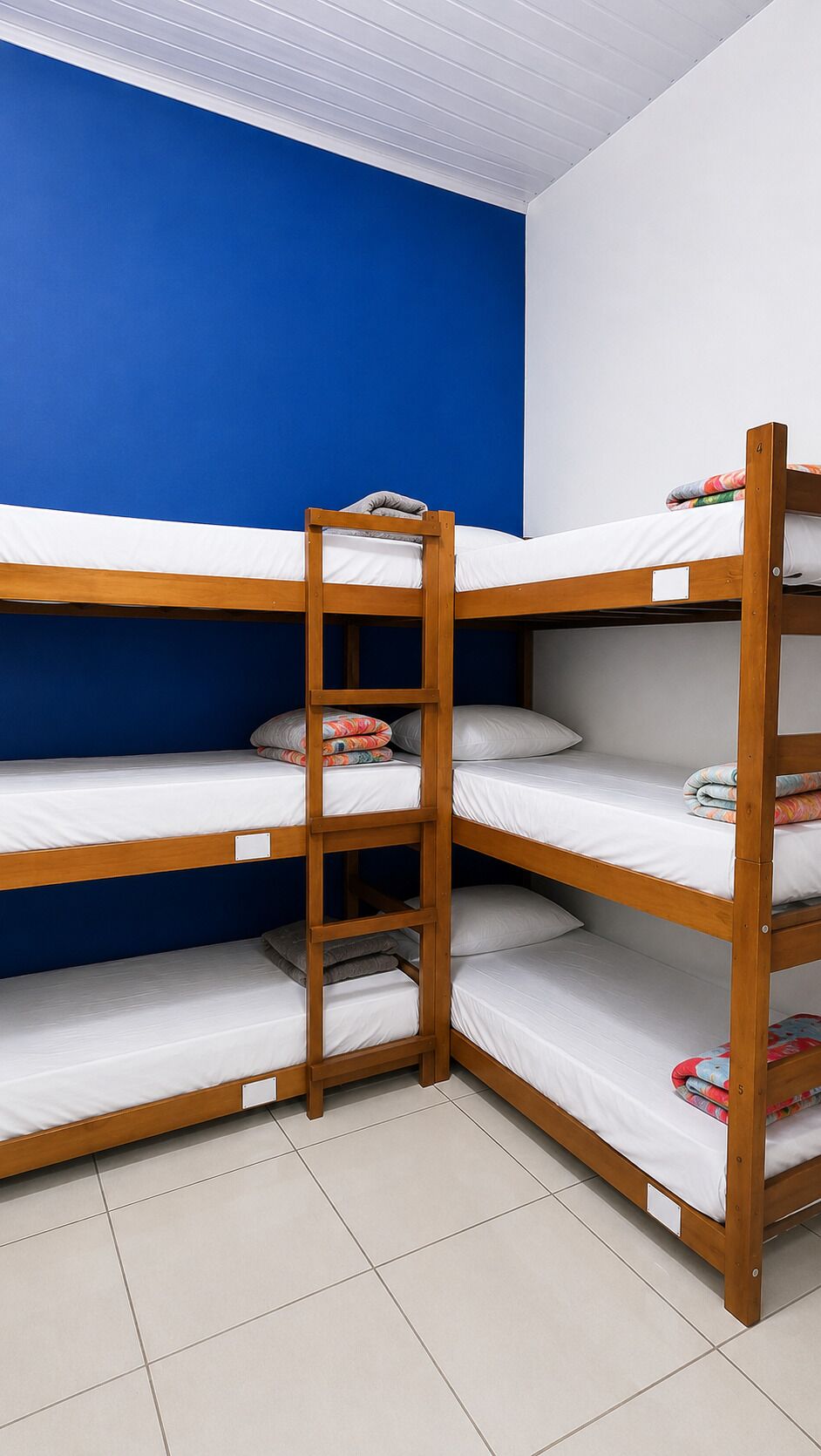 A bunk bed room with blue walls and white ceiling.