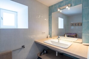 A modern bathroom with a large mirror, a sink, and a window. - Gîte du Boy (sleeps 8) (LANUEJOLS)