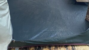 A tent with a bed, a table, and a bench. - Charming cabin tent campground in peaceful Frenchtown for your getaway (Frenchtown)