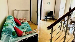 A room with a bed, a TV, a cabinet, and a radiator. - Beautiful cottage with garden Resort Adamo& Eva (Numana)
