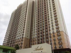 A high-rise building with multiple balconies and a sign reading "Aralea". - Cozy And Roomy Studio Space At Apartment Azalea Suites (Cikarang)