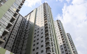 A high-rise residential building with multiple balconies and a clear sky. - Practical 2Br For 3 Pax Near Braga At Grand Asia Afrika Apartment (Bandung)