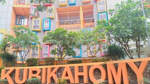 A multi-story building with colorful window frames and a prominent sign reading "KURIKAHOMY". - Comfy And Nice Studio (No Kitchen) At Apartment Kubikahomy (Pagedangan)
