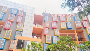 A building with colorful air conditioning units and the name "KUBIKAHOMY" on the facade. - Comfy And Nice Studio (No Kitchen) At Apartment Kubikahomy (Pagedangan)