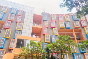 A building with colorful air conditioning units and the name "KUBIKAHOMY" on the facade. - Comfy And Nice Studio (No Kitchen) At Apartment Kubikahomy (Pagedangan)