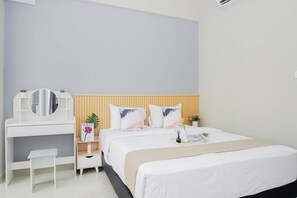 A bedroom with a bed, a bedside table, a mirror, and a dresser. - Neat And Restful Studio At Apartment Lrt City Sentul - Royal Sentul Park (Bogor)