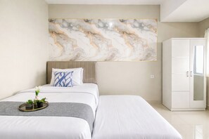 A hotel room with a bed, a wardrobe, and a marble wall. - Functional Studio At Royal Sentul Park Apartment (Bogor)