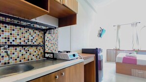 A modern kitchen with a tiled backsplash, a built-in stove, and a sink.