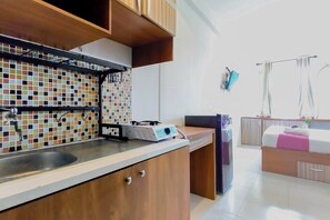 A modern kitchen with a tiled backsplash, a built-in stove, and a sink.