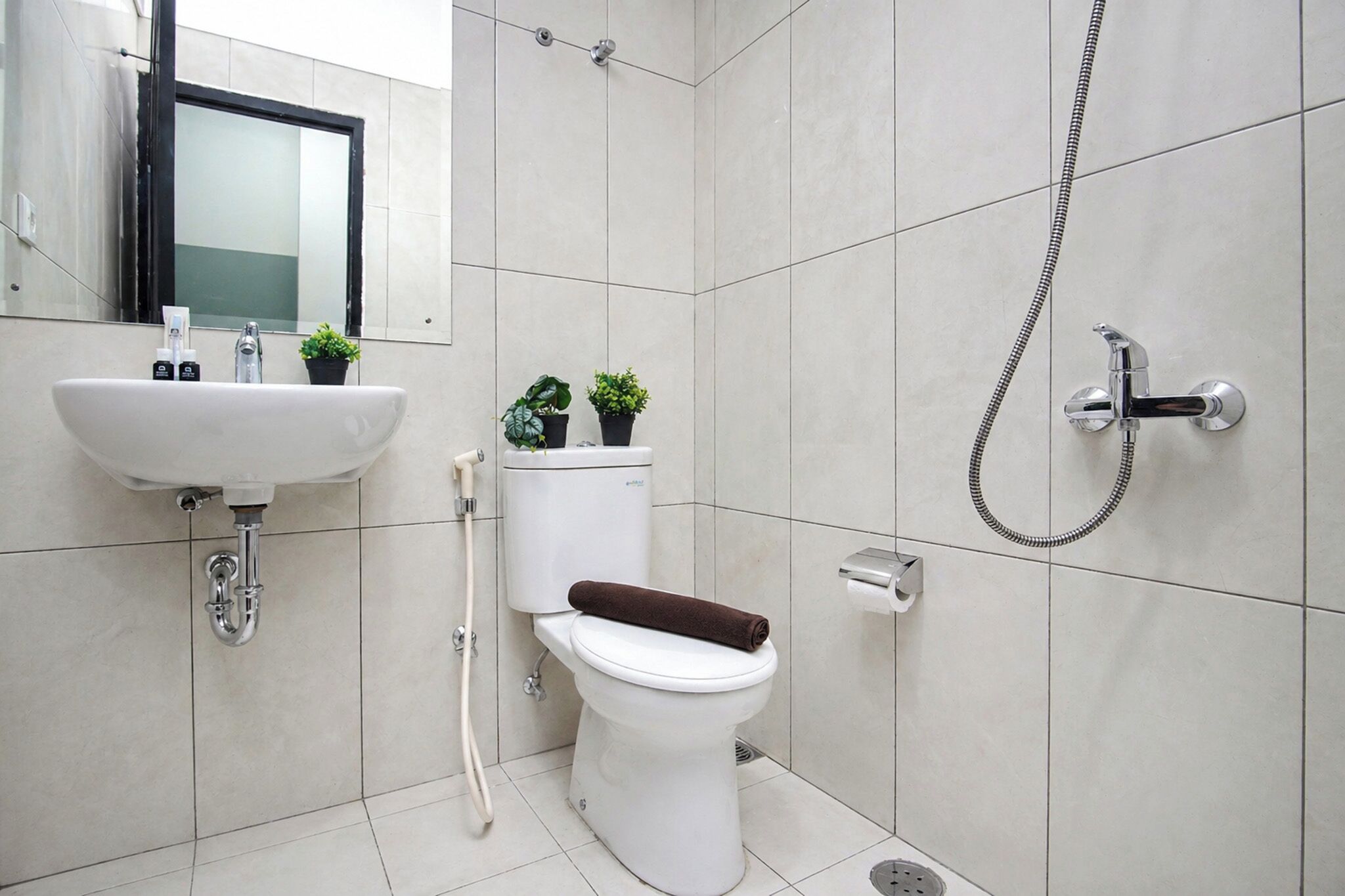 Een badkamer met wastafel, toilet en douche.