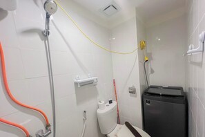 A bathroom with a shower, toilet, and a black trash bin. - Compact Studio Apartment For 2 Pax At Sentraland Medan (Medan)