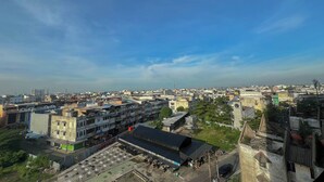 An urban landscape with buildings, a large open area, and a clear sky. - Compact Studio Apartment For 2 Pax At Sentraland Medan (Medan)