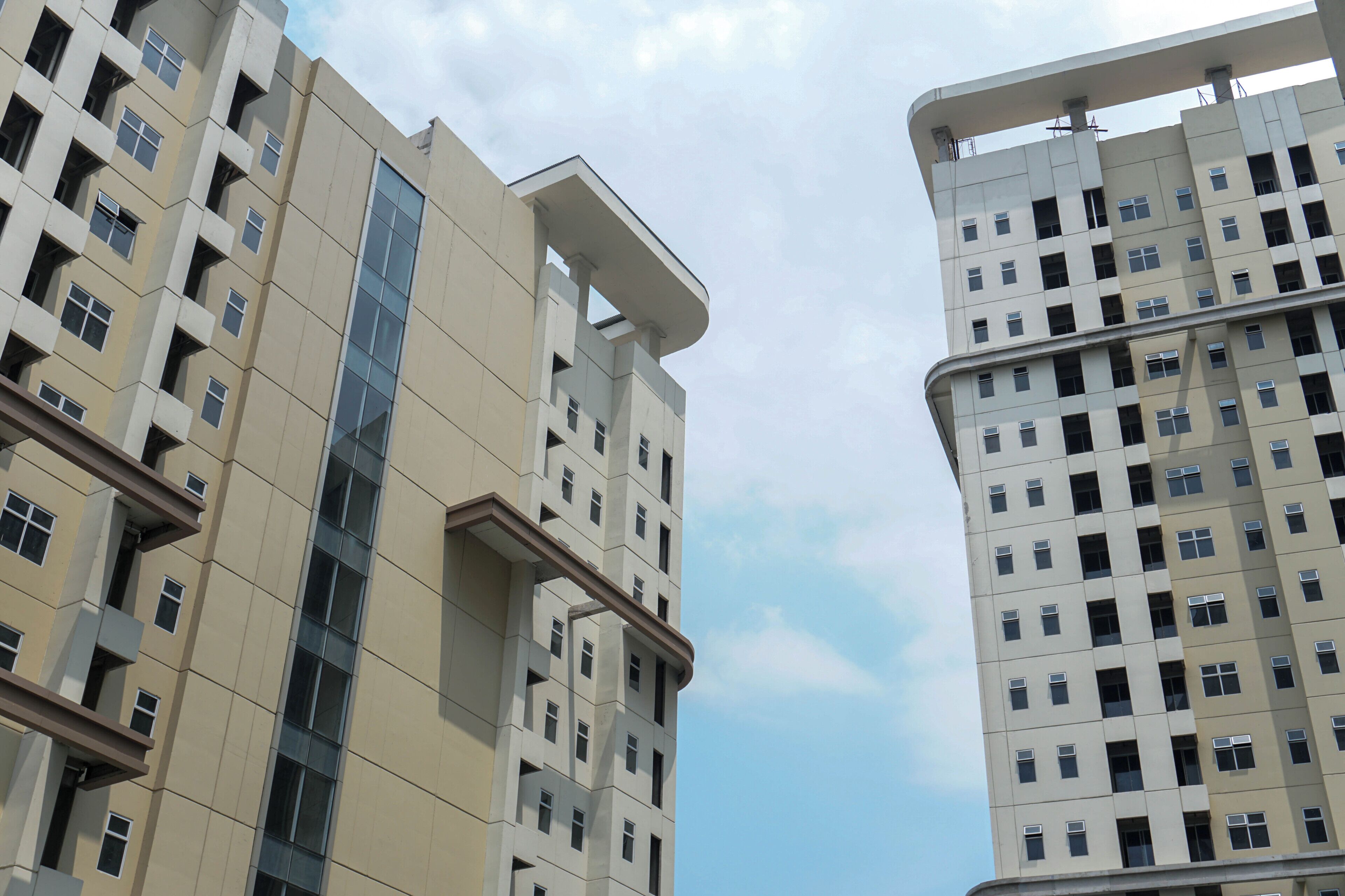 A high-rise building with multiple floors, large windows, and a modern architectural design.