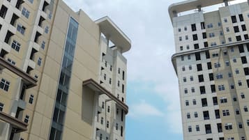 A high-rise building with multiple floors, large windows, and a modern architectural design.