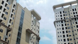 A high-rise building with multiple floors, large windows, and a modern architectural design. - Relaxing And Cozy 1Br Apartment At Vittoria Residence (Jakarta)