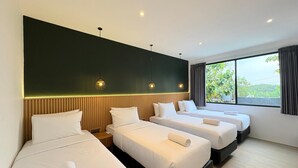 A hotel room with three beds, a large window with a view, and a green accent wall. - Guru Giri Forest Cabin Villa 2BR for 8 Pax (Include Breakfast) (Srimulyo)