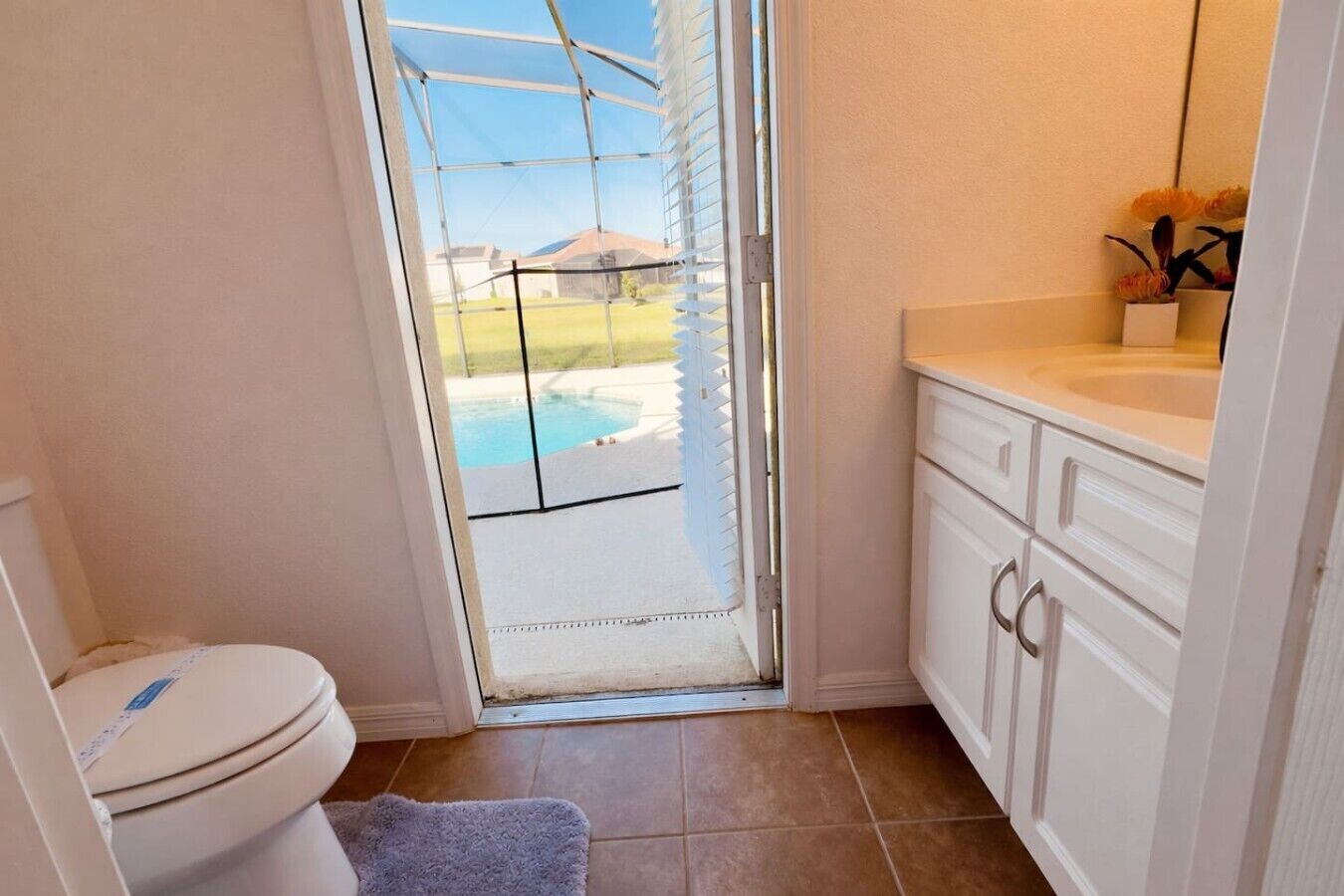 A bathroom with a toilet, a sink, and a shower area.