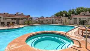 A swimming pool with a hot tub, surrounded by buildings with red-tiled roofs. - Amira Resort #17 | Studio | Near Pool & Pickleball (Saint George)